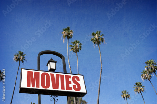 aged and worn vintage movies sign with palm trees