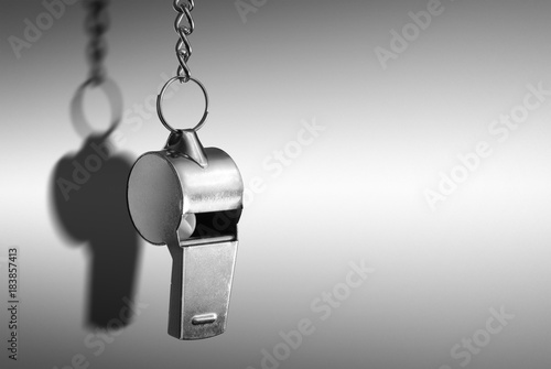 Hanging metal whistle closeup photo photo
