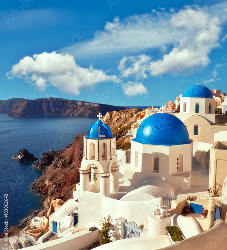 Local church with blue cupola in Oia village in Santorini  panoramic image