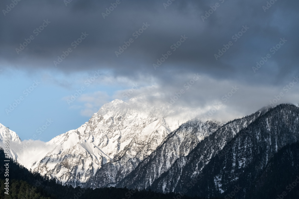snow capped mountain and misty clouds