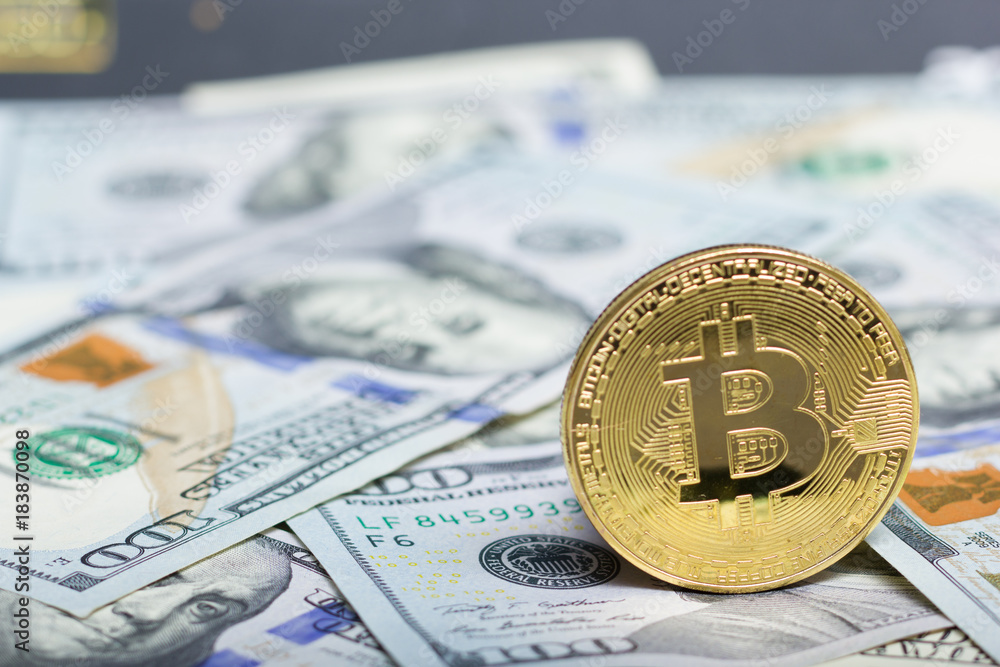 Bitcoin golden coin New virtual money and dollar background . Cryptocurrency. Business and Trading concept. Close-up shot Bitcoin golden coin New virtual money and dollar background . Cryptocurrency. Business and Trading concept. Close-up shot