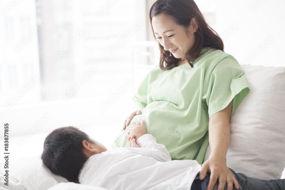 A mother and son touching together with smile A mother and son touching together with smile