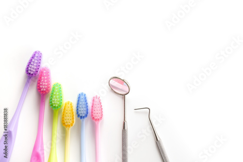 dental mirror  plaque cleaning tool and tooth brush on white background with copy space for your text