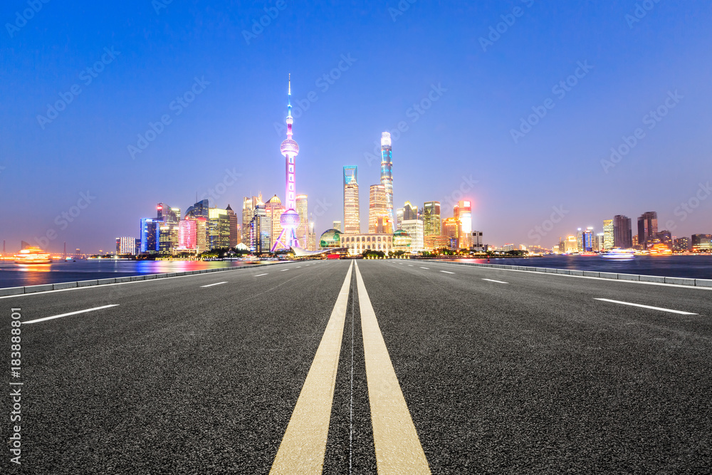 Asphalt road and modern city famous architectural scenery in Shanghai at night,China