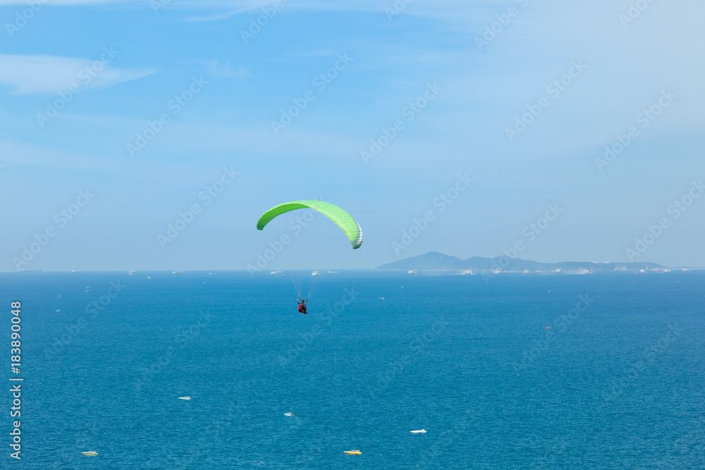 Paragliding flying through the sea and beautiful sky, Koh Lan Pattaya Thailand Paragliding flying through the sea and beautiful sky, Koh Lan Pattaya Thailand