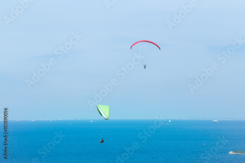Two Paragliding flying through the sea and beautiful sky, Koh Lan Pattaya Thailand