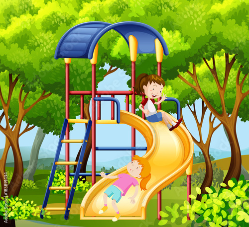 Two girls on the slide in park