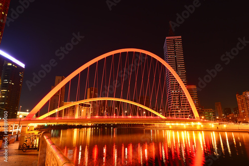 Fototapeta Naklejka Na Ścianę i Meble -  The modern city highway Bridges night landscape car light trails arc in tianjin