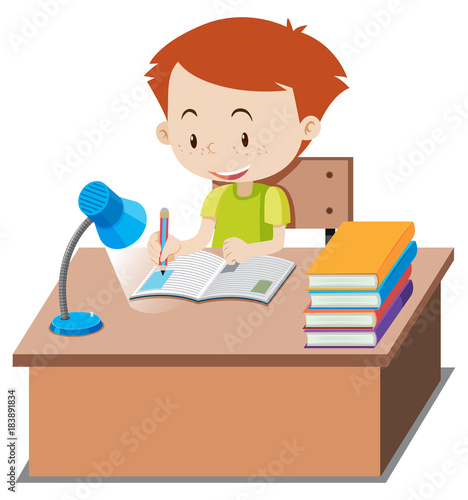 Little boy doing homework on table