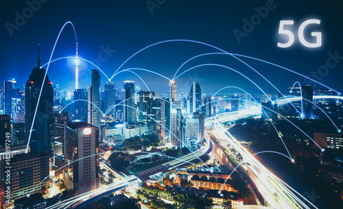 5G network wireless systems and internet of things with modern city skyline. Smart city and communication network concept . photo