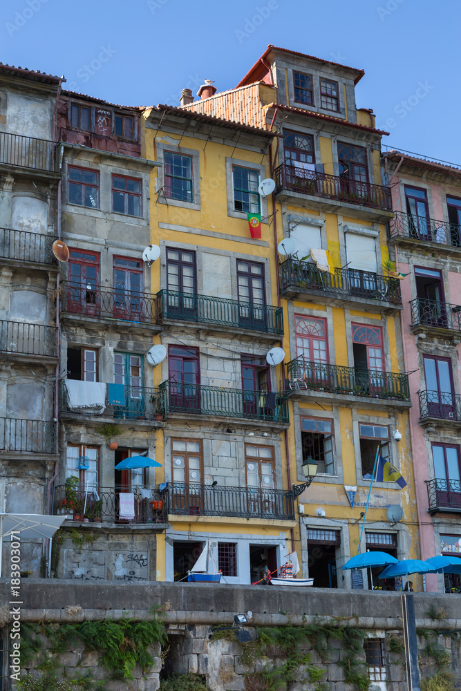 Typical Colorful Portuguese Architecture: Tile Azulejos Facade with Antique Windows And Balcony - Portugal