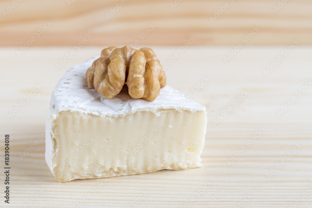 camembert and walnut on wooden background camembert and walnut on wooden background