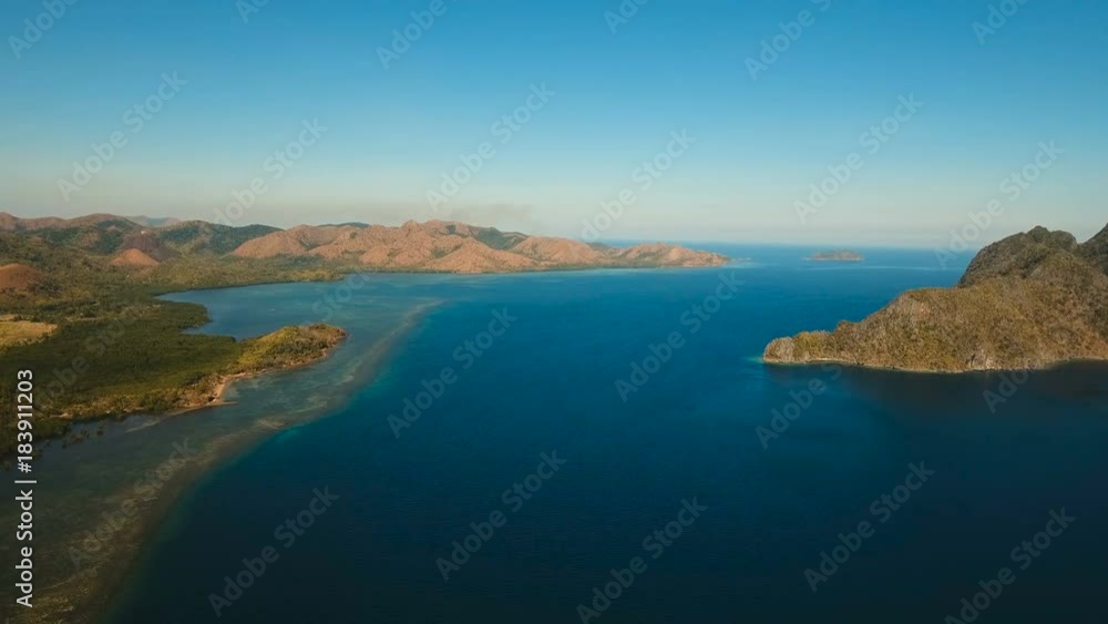 Aerial view: beach, tropical island, sea bay and lagoon, mountains with rainforest, Busuanga, Palawan. Seascape, tropical landscape. Azure water of lagoon. Aerial video. Philippines. 4K video Travel Aerial view: beach, tropical island, sea bay and lagoon, mountains with rainforest, Busuanga, Palawan. Seascape, tropical landscape. Azure water of lagoon. Aerial video. Philippines. 4K video Travel