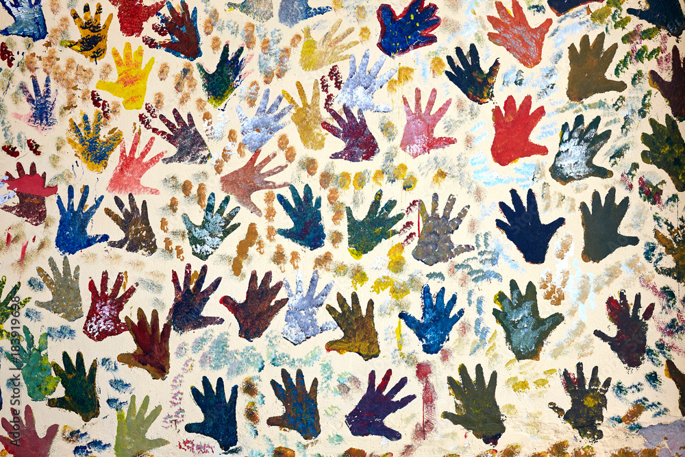 Obraz premium Wall painted with several hand palm marks.