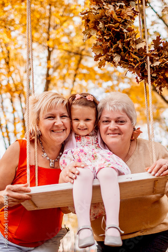 Grandmothers embracing their granddaughter