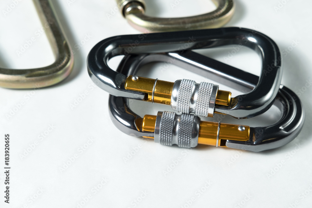 several large professional aluminum and steel carabiners for climbing on white background several large professional aluminum and steel carabiners for climbing on white background