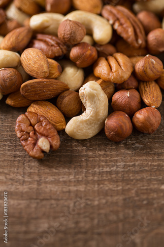 mixed nuts on wooden surface