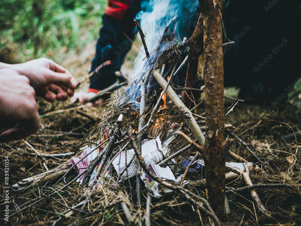 Obraz premium close up shot of man making a fire in the forest
