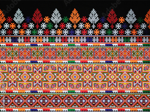 CLOSE UP THE SEAMLESS PATTERN OF COLORFUL CLOTHES. THE HANDMADE EMBROIDERY DID BY HILL TRIBE WOMEN.