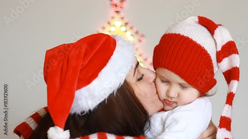 Christmas. Portrait of a happy mother and her child. Mom embraces with love the daughter. New year and magic. Close-up. photo