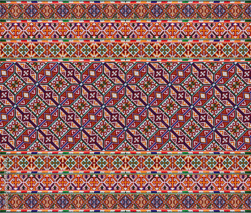 CLOSE UP THE SEAMLESS PATTERN OF COLORFUL CLOTHES. THE HANDMADE EMBROIDERY DID BY HILL TRIBE WOMEN.
