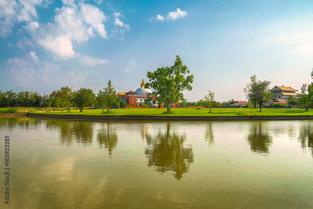 magical landscape with small lake and beautiful reflections in land of temples in nepal. lumbini magical landscape with small lake and beautiful reflections in land of temples in nepal. lumbini