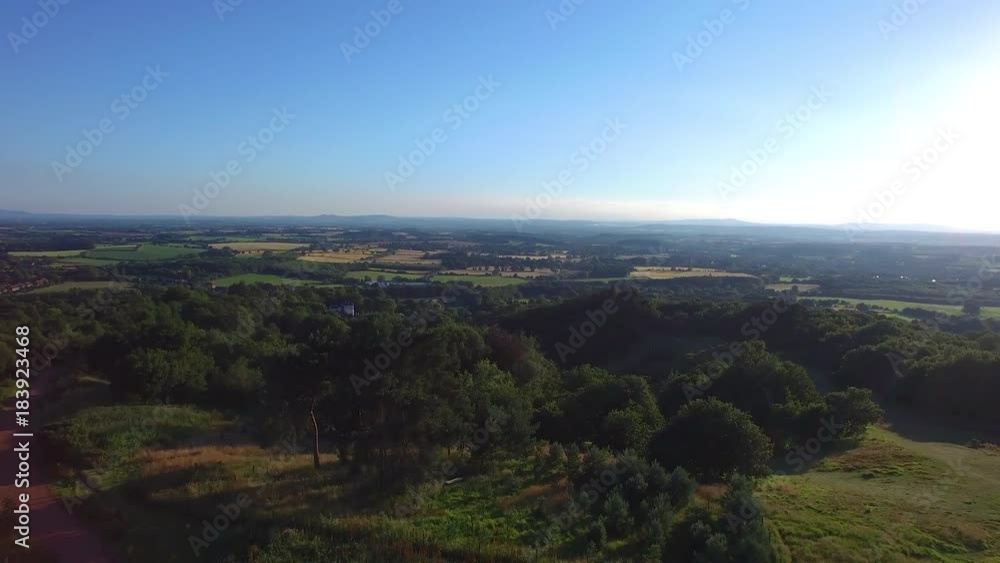 A slow motion aerial shot of a wide green fields. A slow motion aerial shot of a wide green fields.