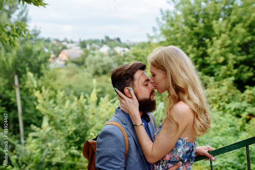 Young couple in love outdoor.Stunning sensual outdoor portrait of young stylish fashion couple posing in summer