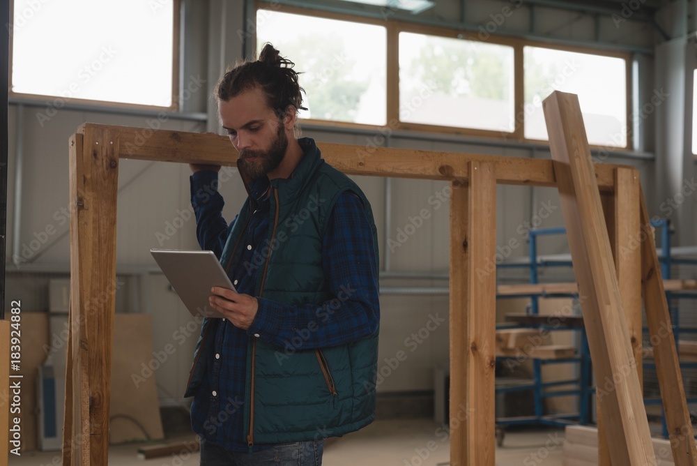 Carpenter using digital tablet Carpenter using digital tablet