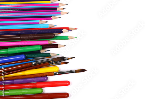 Colorful felt pen markers, pencils, paint brushes and art utensils isolated on white background, top view