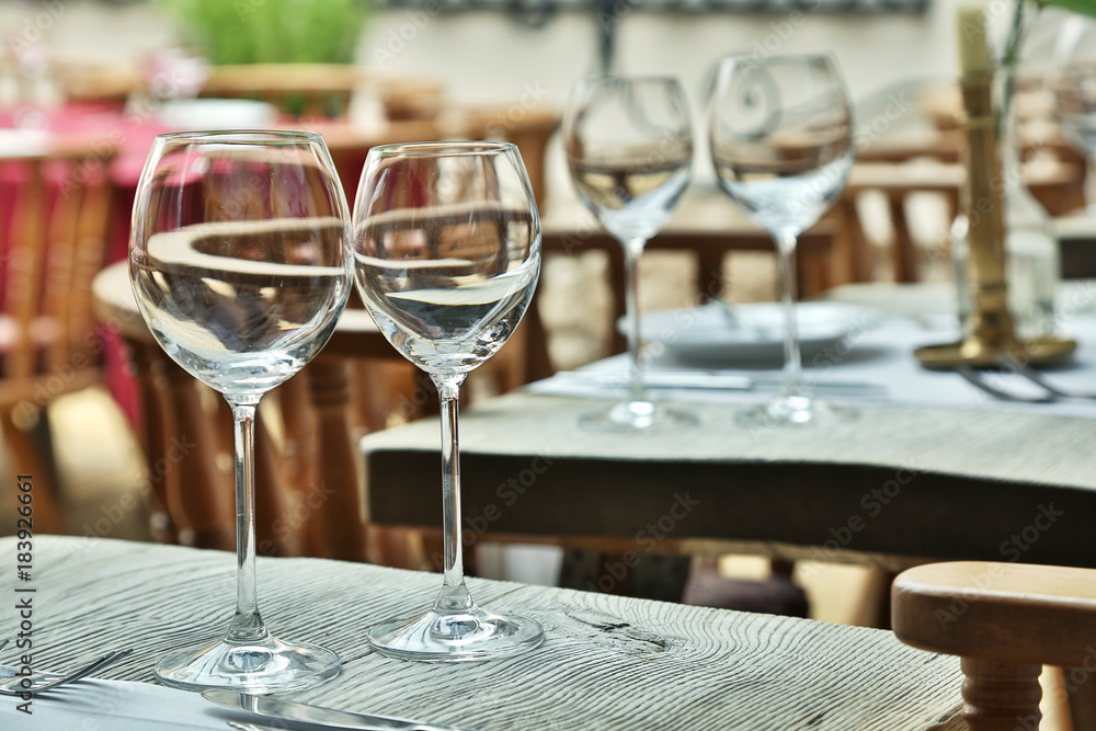 Fototapeta premium Table setting with wine glasses at the vintage cafe.
