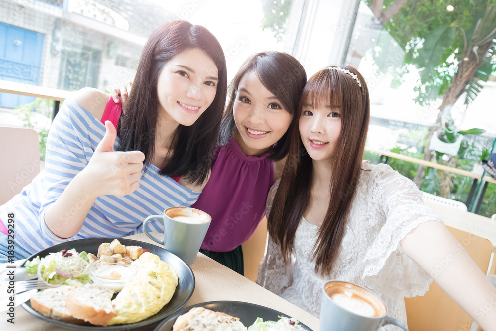 happy woman friends in restaurant