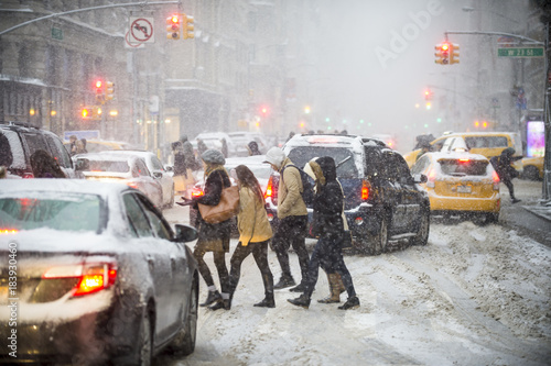 Pedestrians trying to cross a traffic jam when a  winter snowstorm brings chaos to Midtown Manhattan, New York City