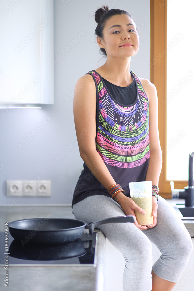 Fitness girl cooking healthy food in the kitchen. Woman. Kitchen. Cooking Fitness girl cooking healthy food in the kitchen. Woman. Kitchen. Cooking