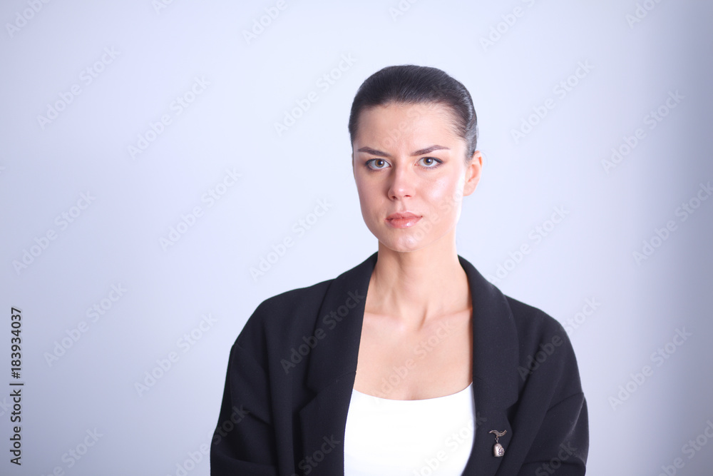Young woman standing, isolated on gray background Young woman standing, isolated on gray background