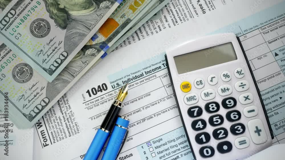 USA tax form 1040 and dollar bills, close up. High angle view.
USA tax form 1040 and dollar bills, close up. High angle view.