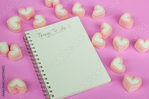 marshmallow heart shape with love concept on pink background © Thanrada H.