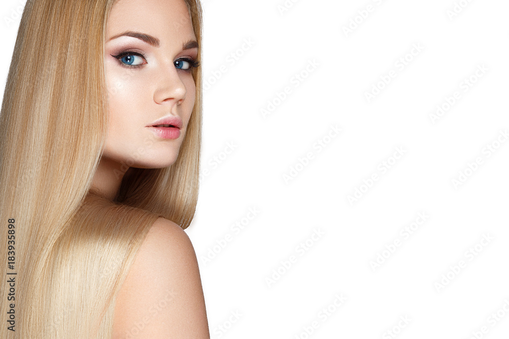 Naklejka premium Beautiful blond girl with a perfectly smooth hair, and classic make-up. Beauty face. Picture taken in the studio.