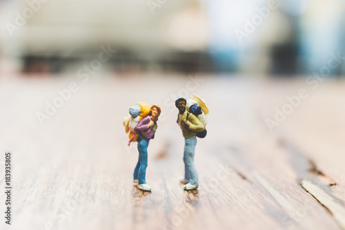 Miniature Backpacker , Tourist people standing on wooden with blurred background