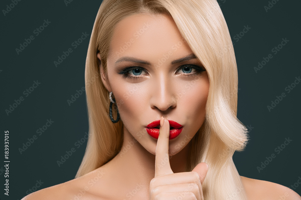 beautiful sensual woman with silence symbol, isolated on grey beautiful sensual woman with silence symbol, isolated on grey