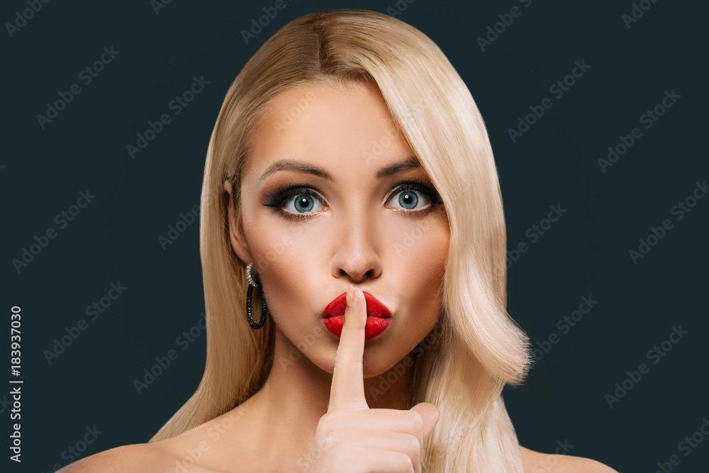 beautiful woman with hush sign looking at camera, isolated on grey beautiful woman with hush sign looking at camera, isolated on grey