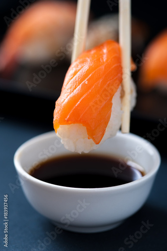 Chopstick with Salmon sashimi and soy sauce. Popular Japanese cuisine