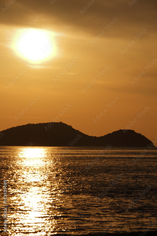 The setting sun and island