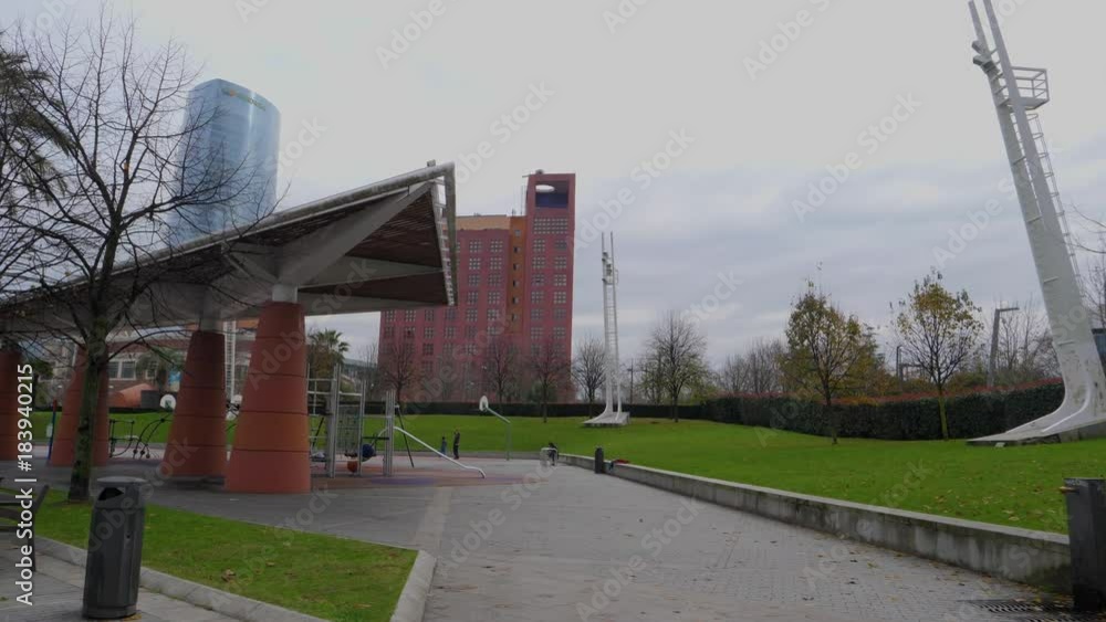 park and modern architecture, bilbao, urban river margin in autumn park and modern architecture, bilbao, urban river margin in autumn
