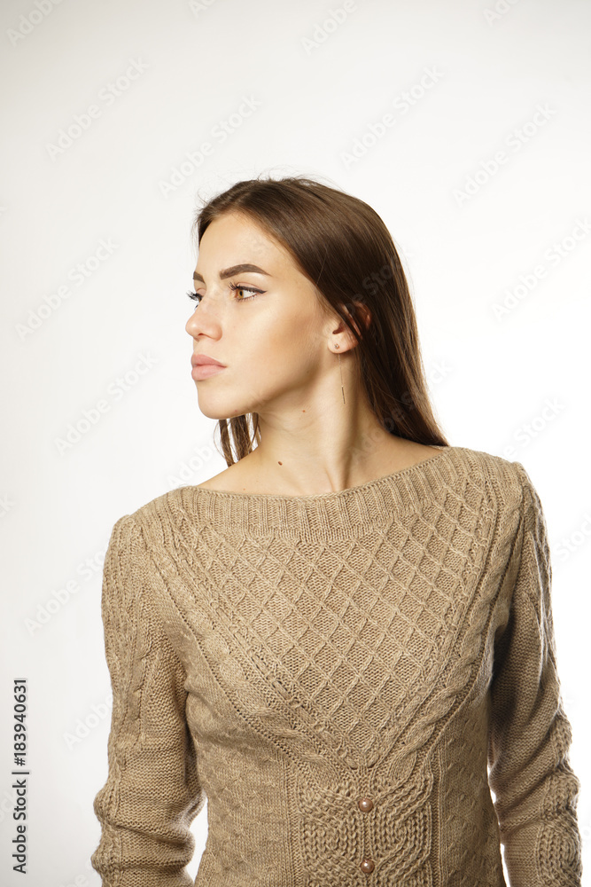 the girl in the beige sweater over a white background the girl in the beige sweater over a white background