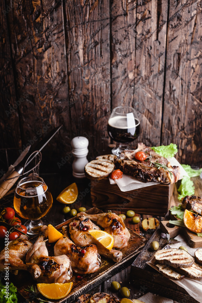 delicious grilled meat with vegetables and beer