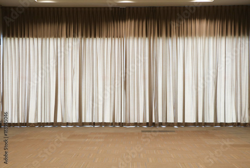 Brown curtains in the conference room the floor is carpeted with light brown linen  clean and simple