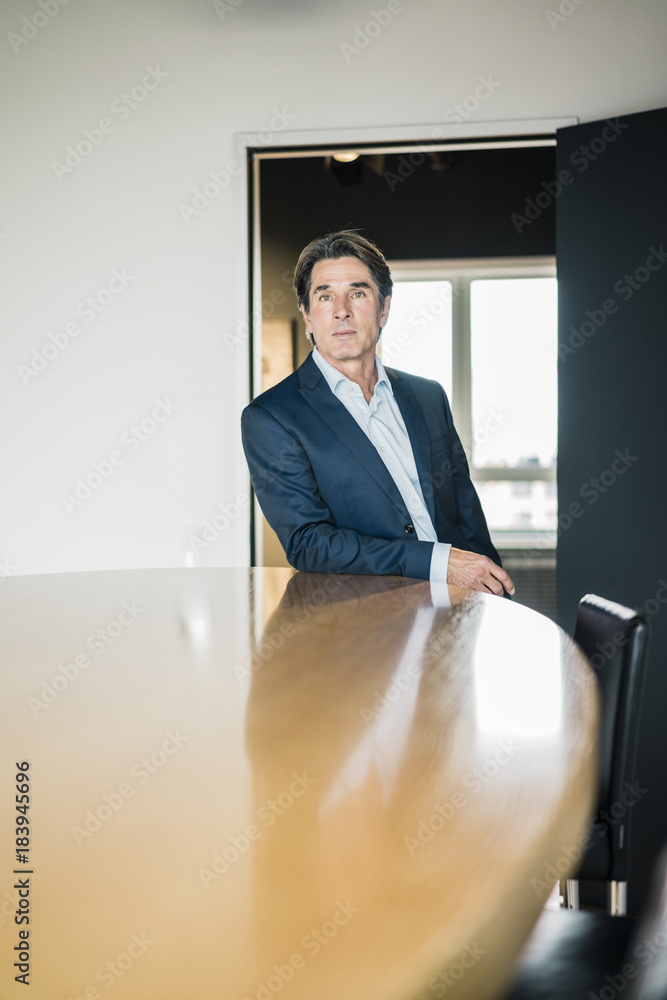 Portrait of businessman in meeting room of an office Portrait of businessman in meeting room of an office
