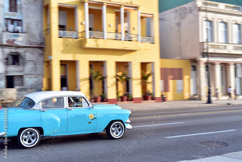 Old car speeding along the road at Malecon, Havana, Cuba