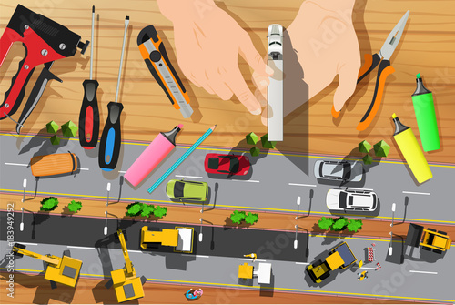 little toy truck in hands and the asphalt highway top view
